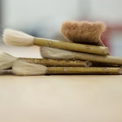 Five types of paint brushes stacked on top of each other